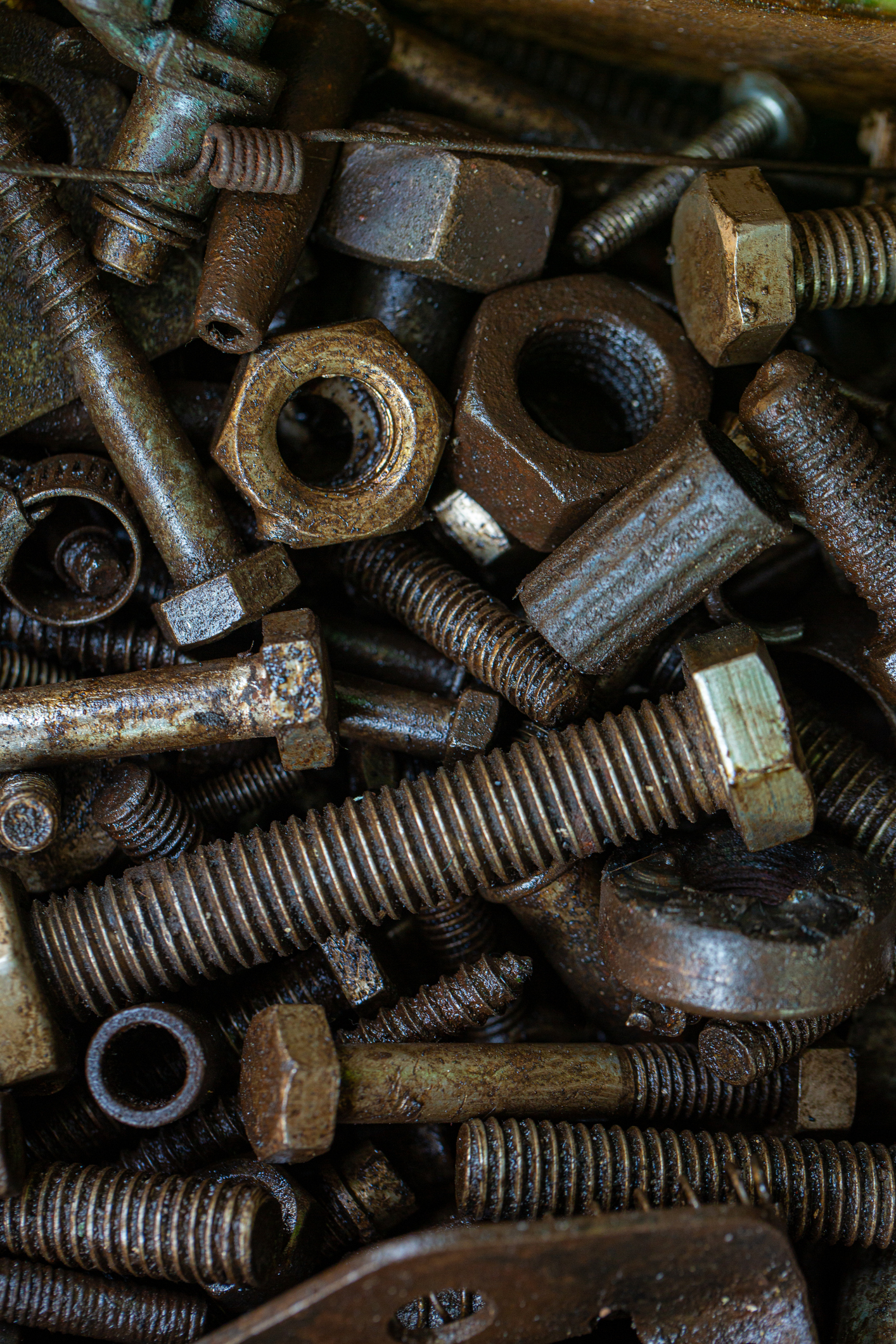 Pile of rustic nuts and bolts in grease,Close-up of a nut with oil stains, Pile of rustic nuts and bolts in grease,Close-up of a nut with oil stains,